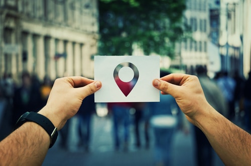 A man holding a Google map location pointer icon as he looks for a small business in Livermore, CA