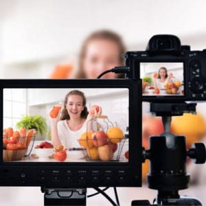 Female online influencer recording healthy food video content for small business YouTube marketing