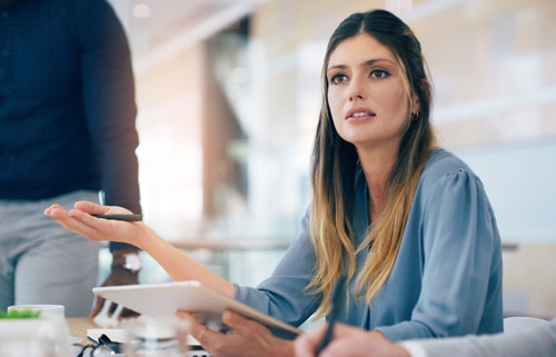 Cropped shot of a businesswoman in a meeting with her hand in air objecting to a salespersons pitch