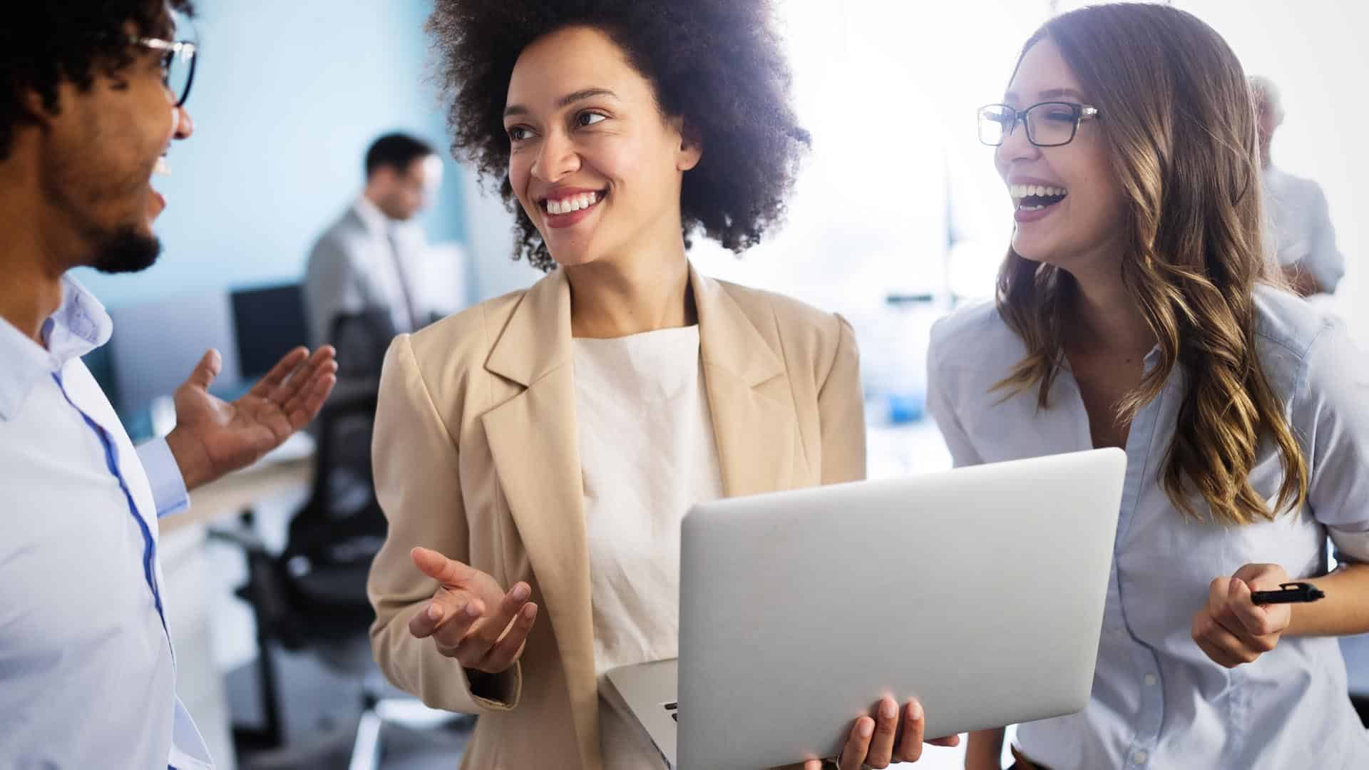 A small business owner smiling while discussing marketing with her digital agency in the office