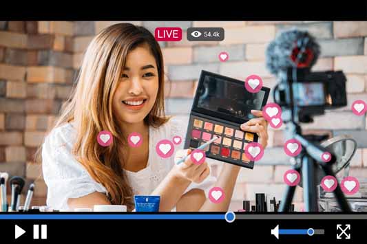 Young woman business owner shows advantages of social media with a live stream makeup tutorial