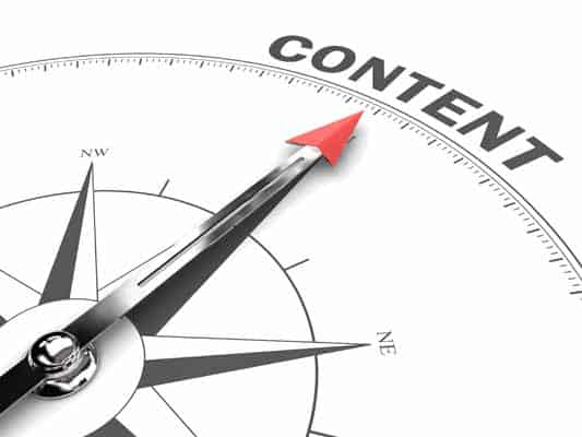 A compass with red-tipped arrow pointing to the word content to convey importance of content for SEO