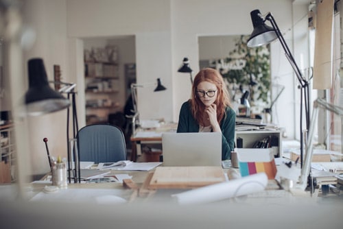 A digital marketing consultant works on client project in empty office without client interaction