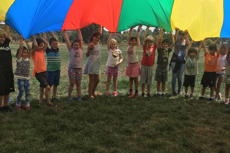 Picture taken by amateur of children at day care center in Dublin California playing parachute game