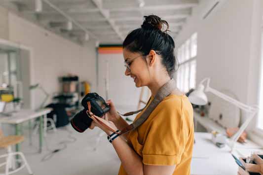 A female local photographer looking at camera screen to review copyrighted product photography