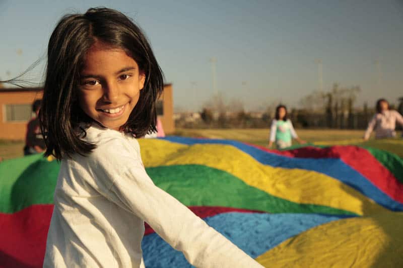 Picture by professional of children at day care center in Dublin California playing parachute game