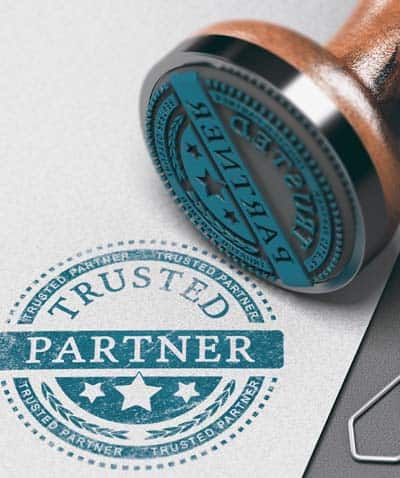 Trusted partner mark imprinted on a paper background with rubber stamp implies importance of trust